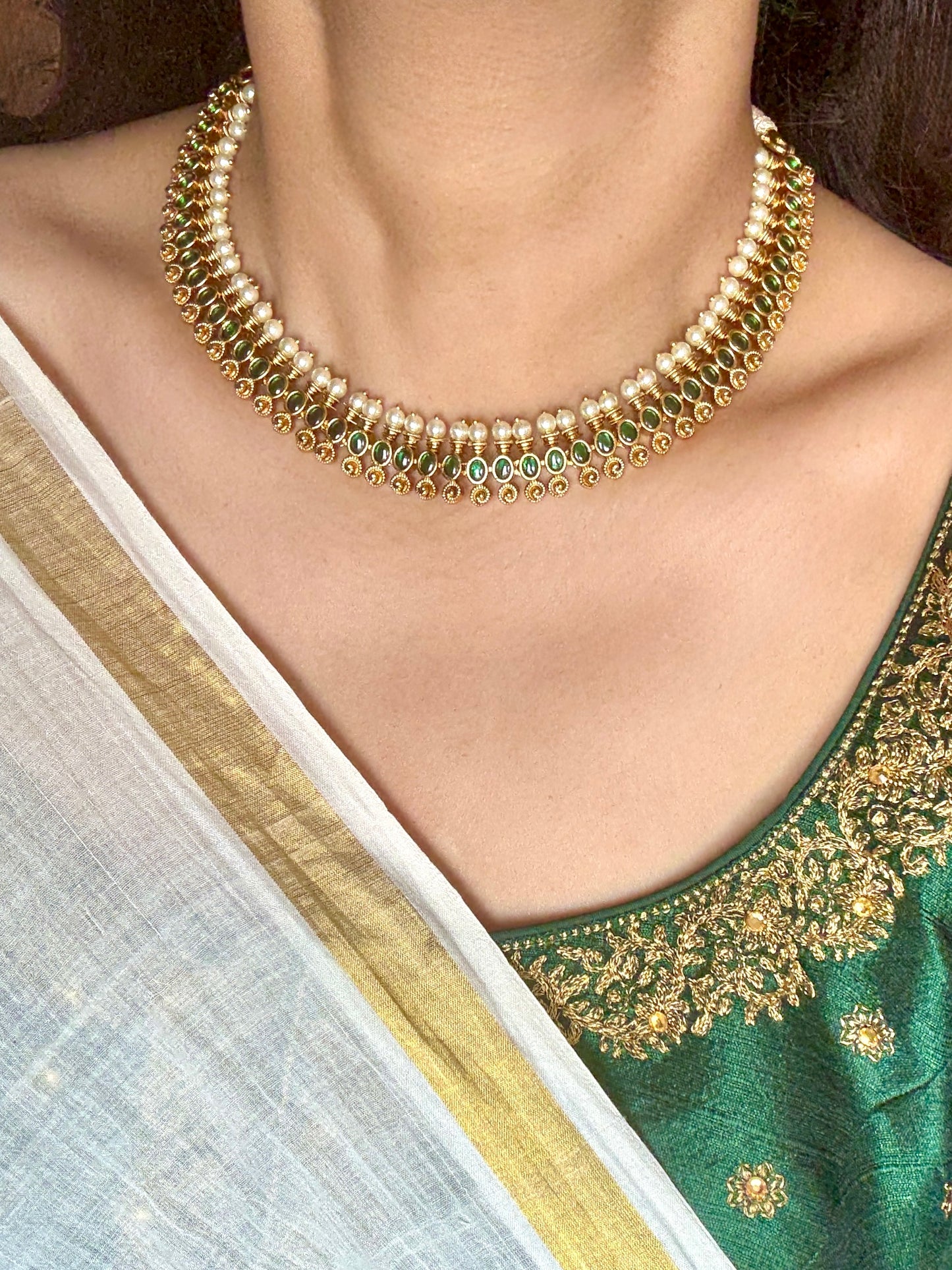 Green stone necklace set with pearls